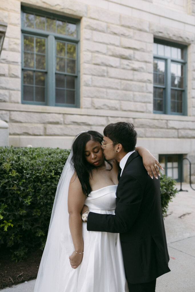 Groom kissing his bride on the cheek