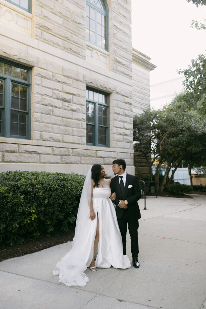 Bride and groom posing outside of Historic DeKalb Courthouse