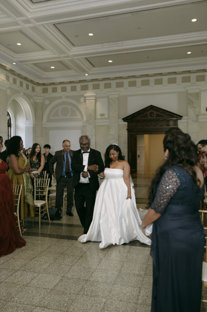 Bride being walked down the aisle by her father