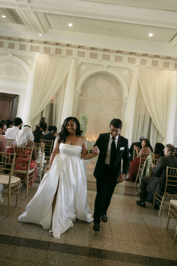 Bride and groom walking back down the aisle as husband and wife after their  intimate Historic DeKalb Courthouse wedding ceremony in Atlanta, Georgia