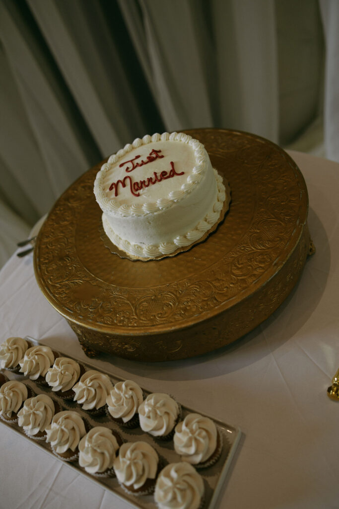 Just married cake next to cupcakes