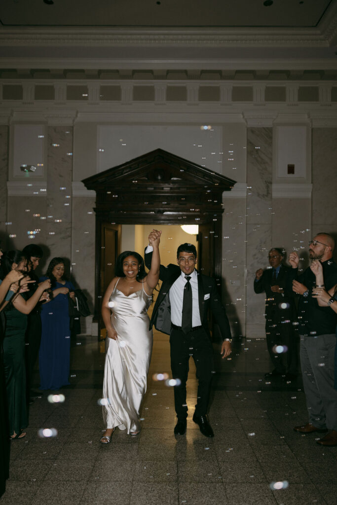 Bride and grooms bubble exit after their intimate Historic DeKalb Courthouse wedding in Atlanta, Georgia