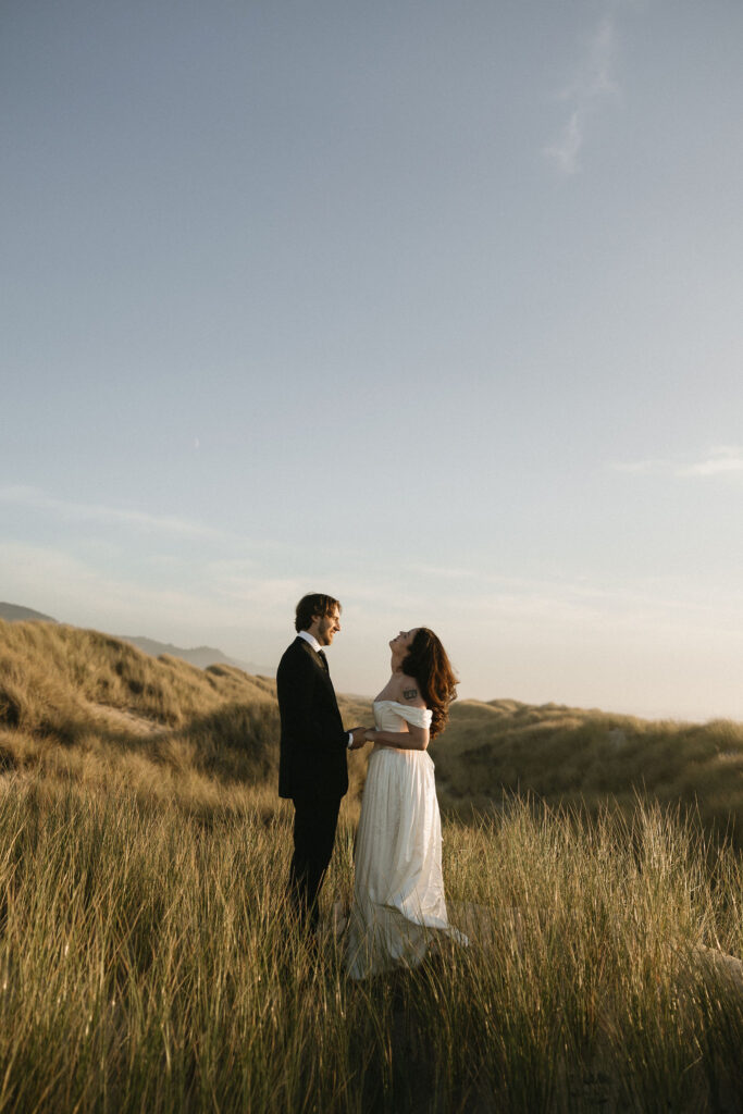 Couple standing in the beach grass for their Northern Oregon Coast elopement