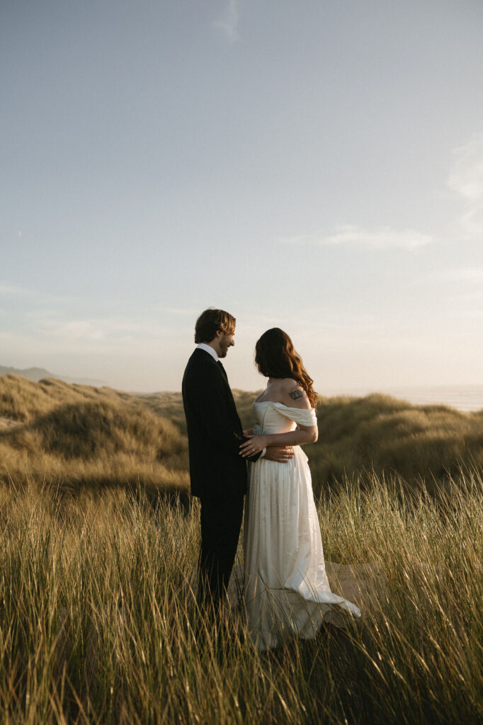 Couple standing in the beach grass for their Northern Oregon Coast elopement