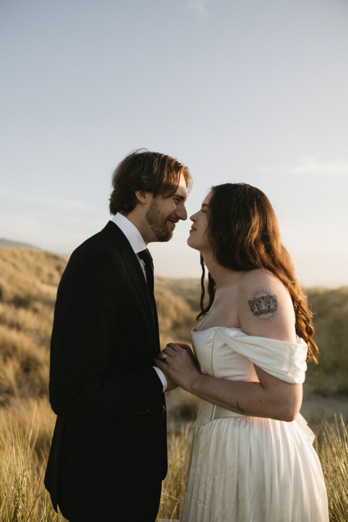 Couple standing in the beach grass for their Northern Oregon Coast elopement