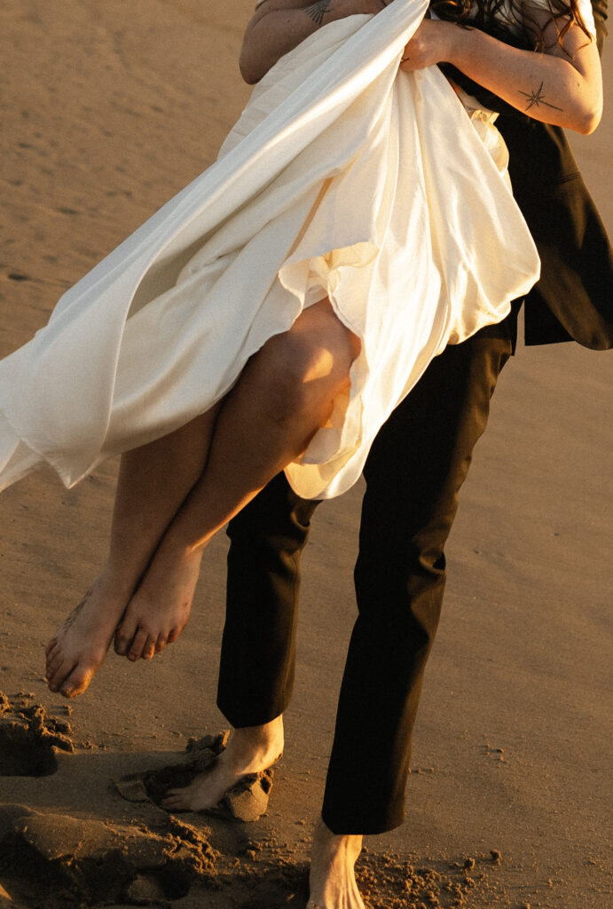 Couple being playful on the Oregon Coast