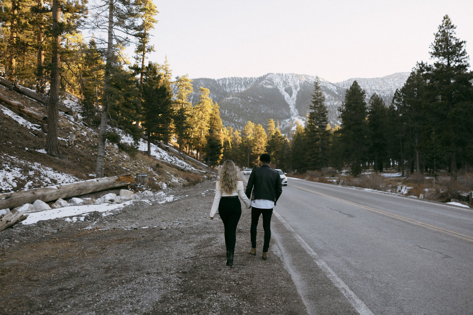 Couple holding hands and walking down the rode - Couples Poses For Photos