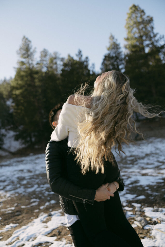 Man twirling his partner during their Mt Charleston photoshoot