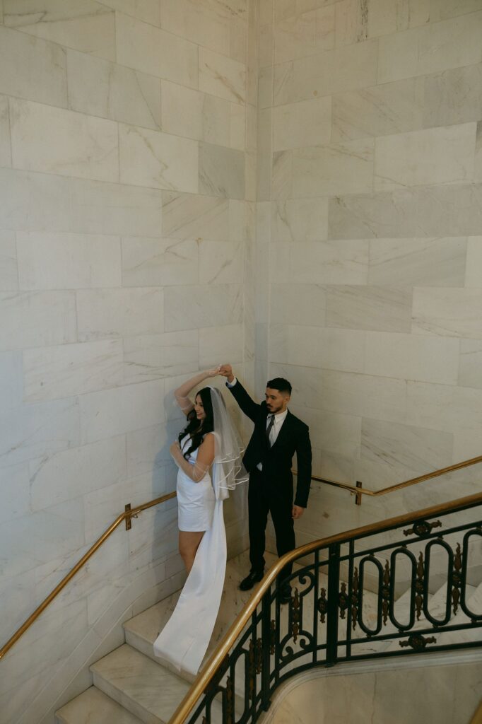 Couple posing on the stairs at San Francisco City Hall