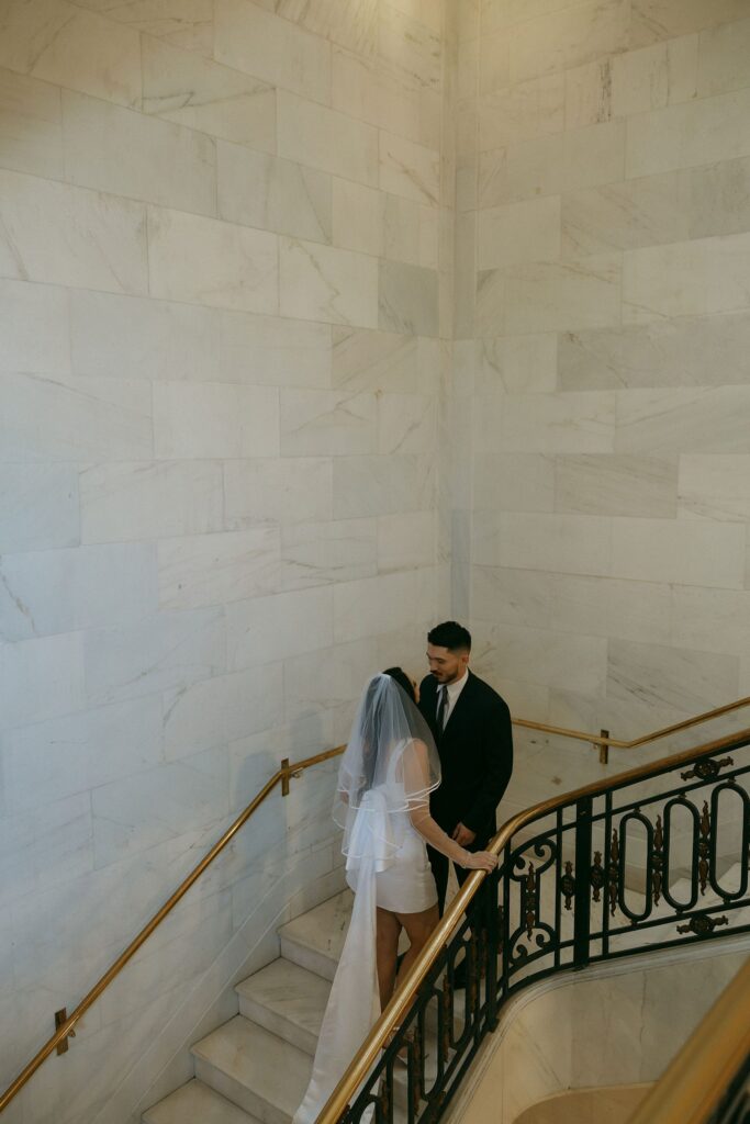 Couple posing on the stairs at San Francisco City Hall