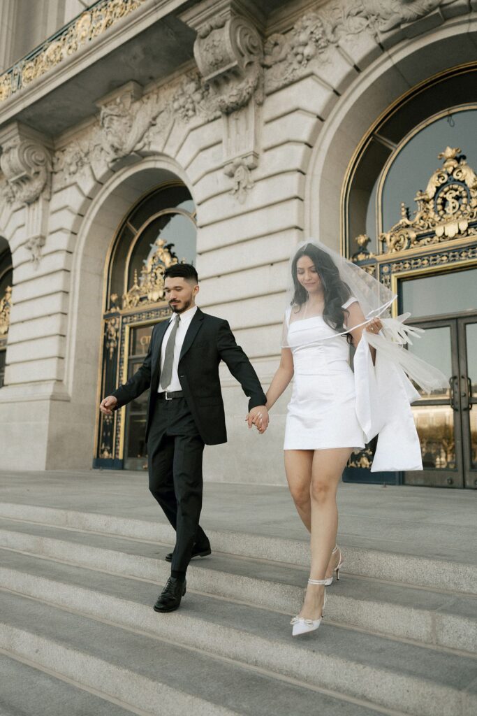 Couple walking down the stairs at the SF City Hall