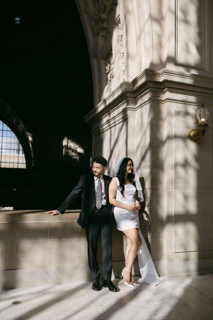 Couple posing at San Francisco City Hall for their engagement photos