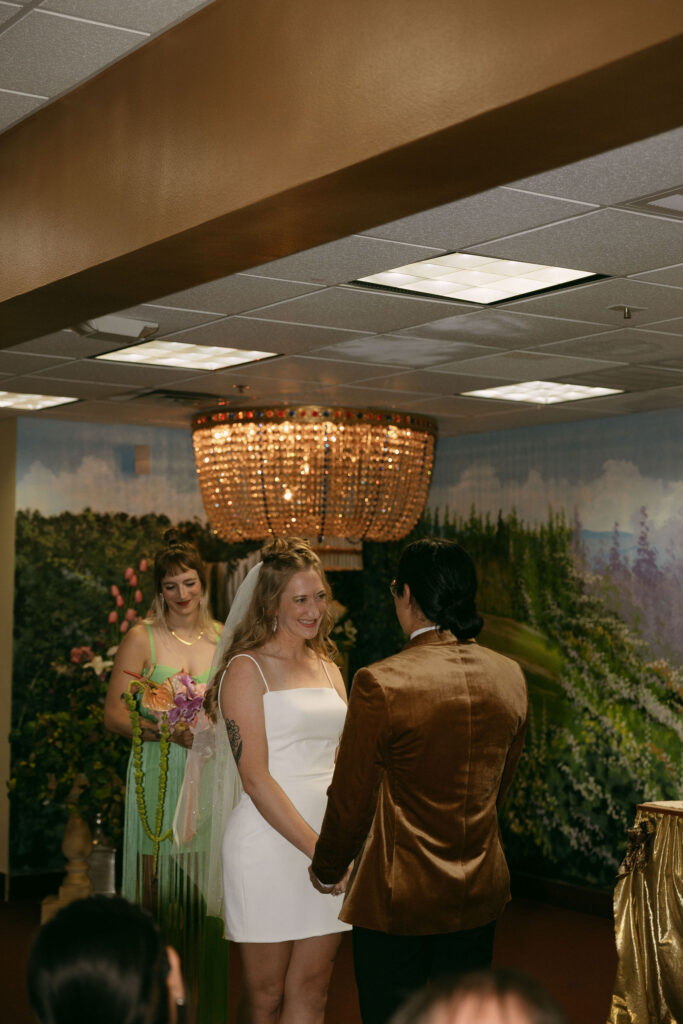 Bride smiling at her groom during their Chapel Amore wedding ceremony