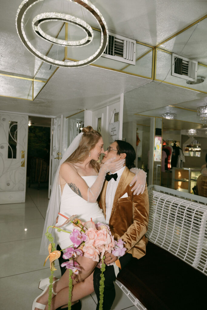 Bride and groom posing in the waiting room at Little White Wedding Chapel