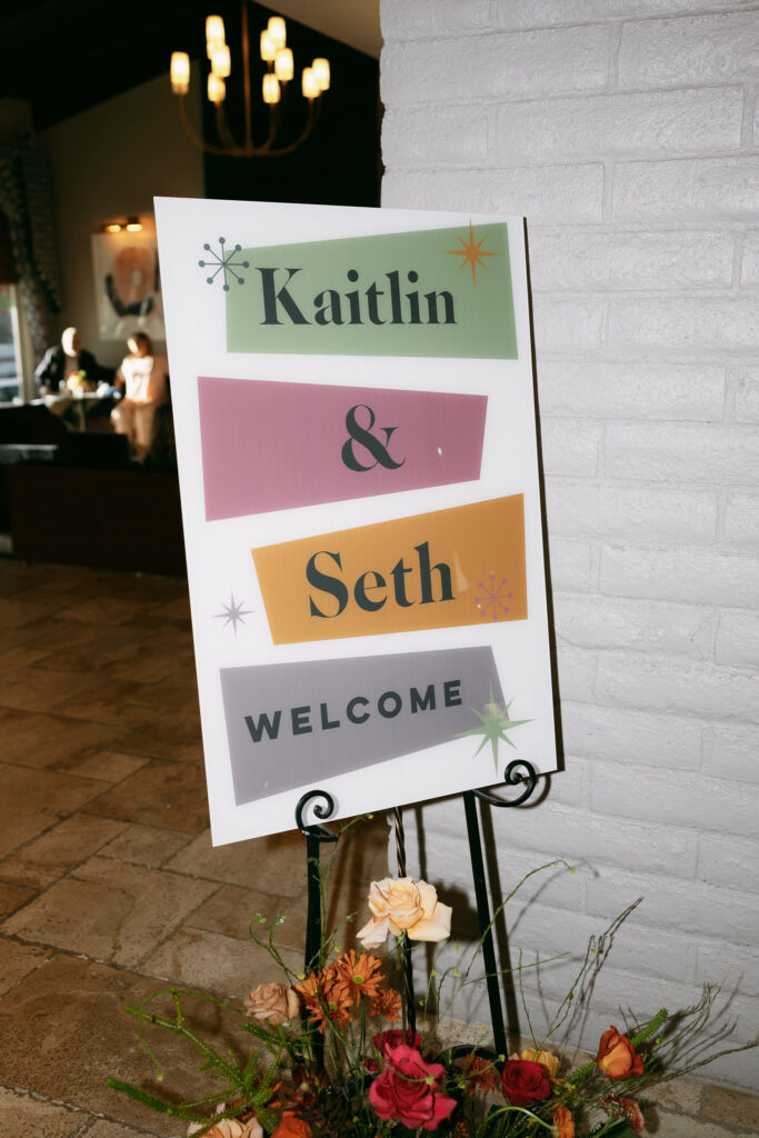 Colorful welcome wedding sign from a Midcentury Manor wedding reception
