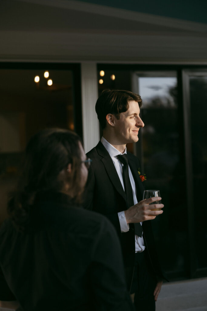 Groom mingling during cocktail hour