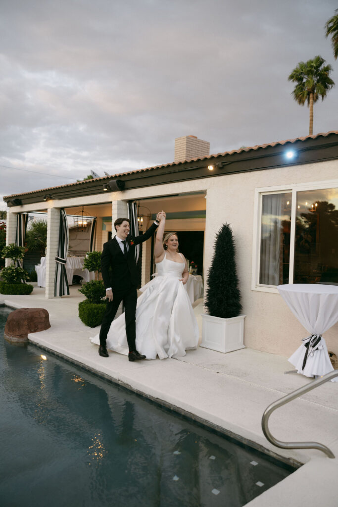 Bride and groom entering their Midcentury Manor wedding reception