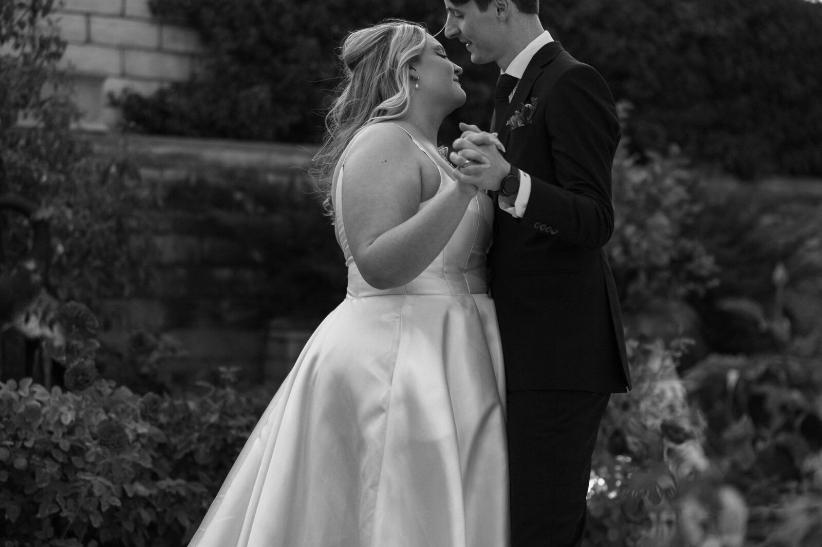 Black and white photo of a bride and groom dancing during their outdoor Las Vegas wedding reception