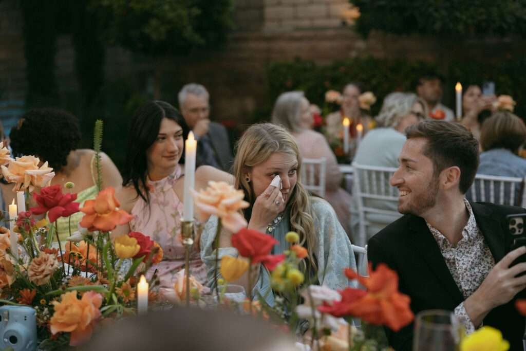 Candid wedding reception photo of guests getting emotional during the father daughter dance