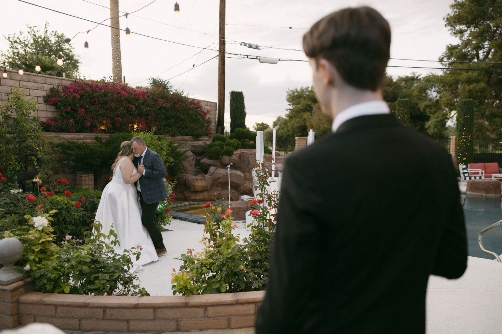 Groom watching the bride dance with her father