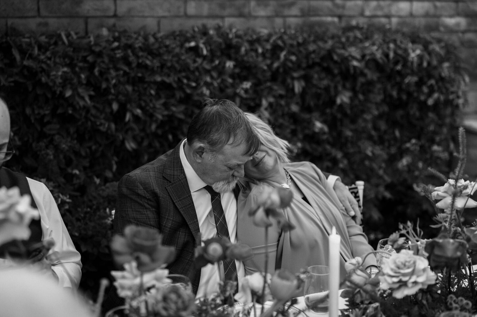 Black and white candid photo of guests getting emotional during the first dances