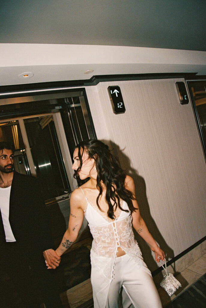 Couple walking out of the elevator for their Bellagio elopement in Las Vegas