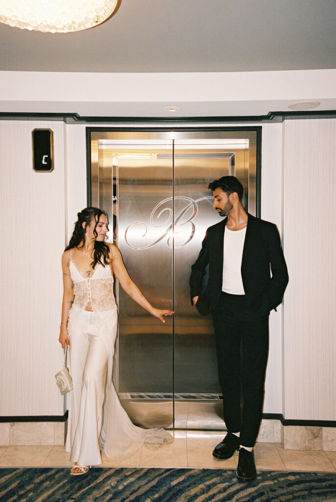 Couple posing in front of an elevator at Bellagio