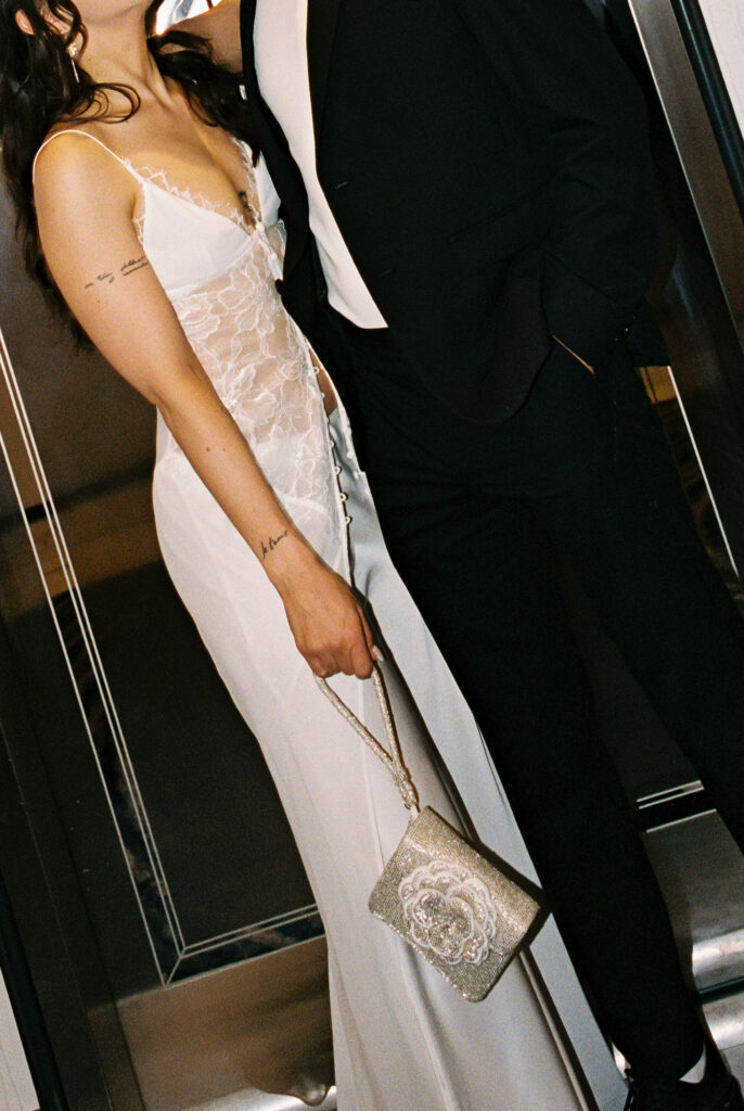 Couple posing in front of an elevator at Bellagio