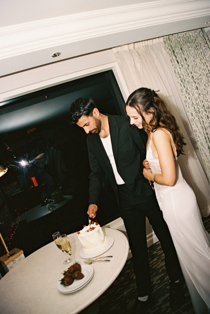 Couple cutting into their elopement cake