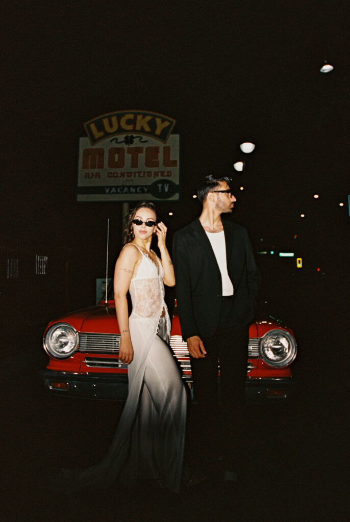 Couples film elopement photos with a red convertible in Las Vegas