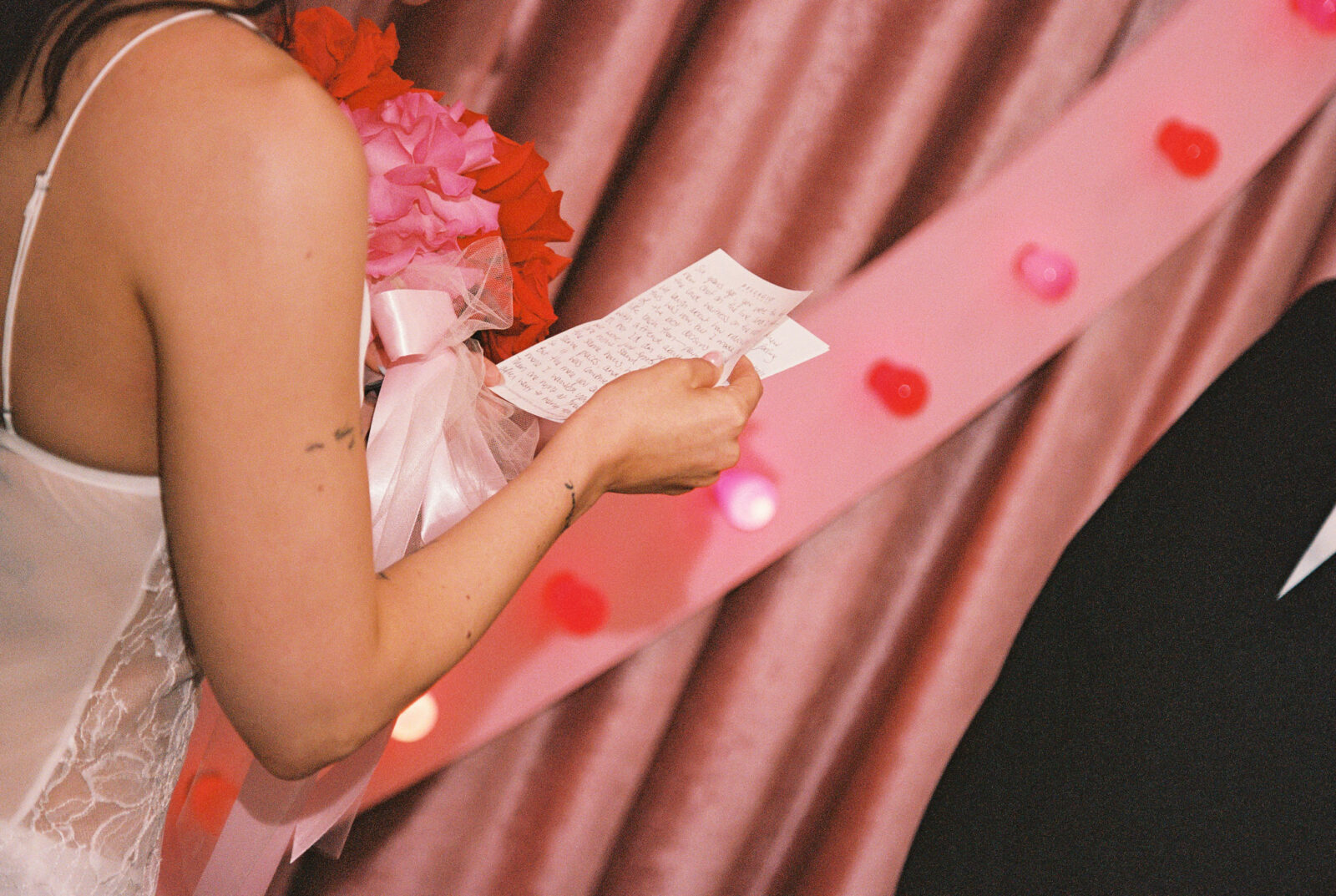 Close up shot of a bride reading her vows to her groom
