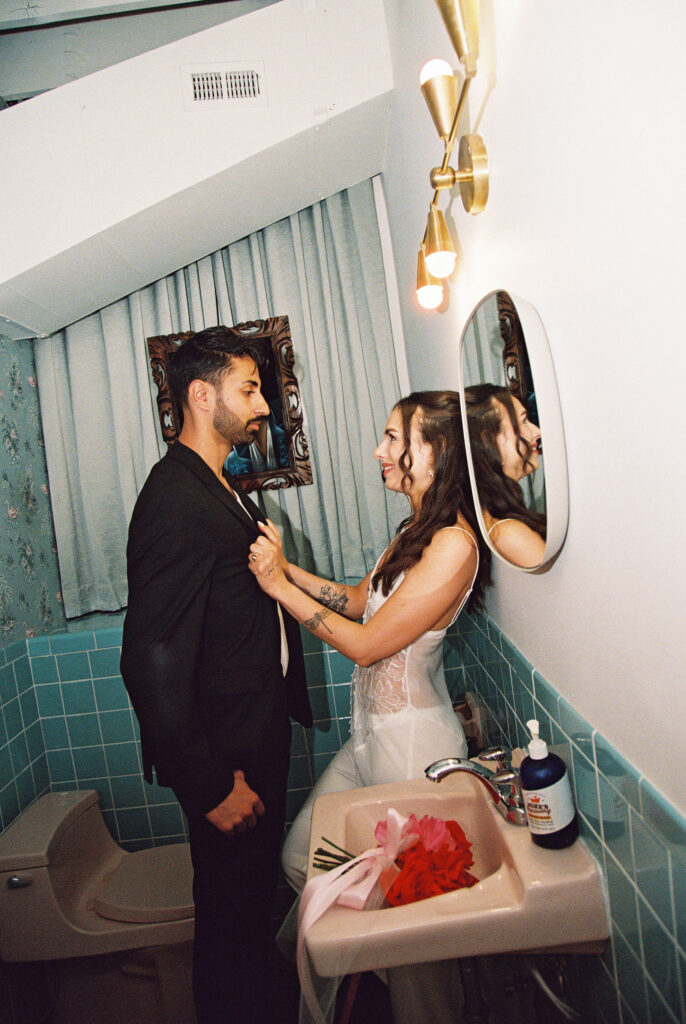 Film Las Vegas elopement photos in the bathroom at Sure Thing Chapel