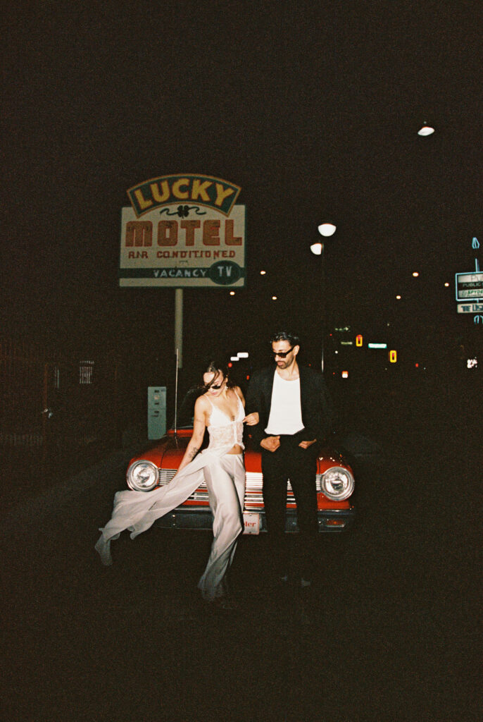 Couples film elopement photos with a red convertible in Las Vegas