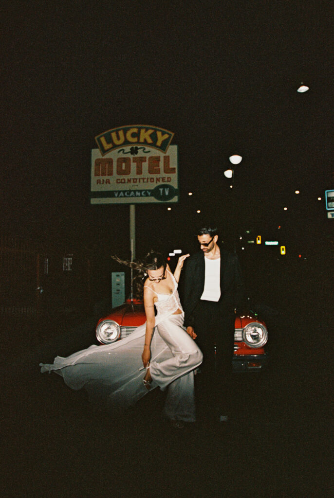 Couples film elopement photos with a red convertible in Las Vegas
