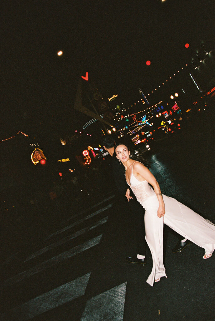 Couple walking across the street for their film Vegas elopement shoot