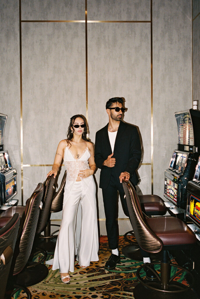 Editorial Vegas elopement photo of a couple posing in a casino