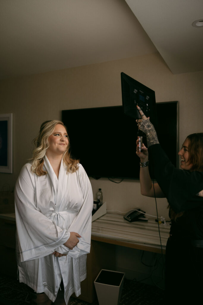 Bride seeing herself with hair and makeup done before her wedding