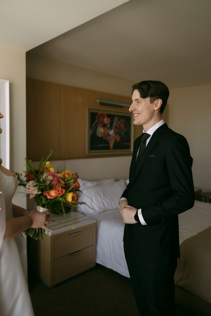Groom smiling at his bride during their first look