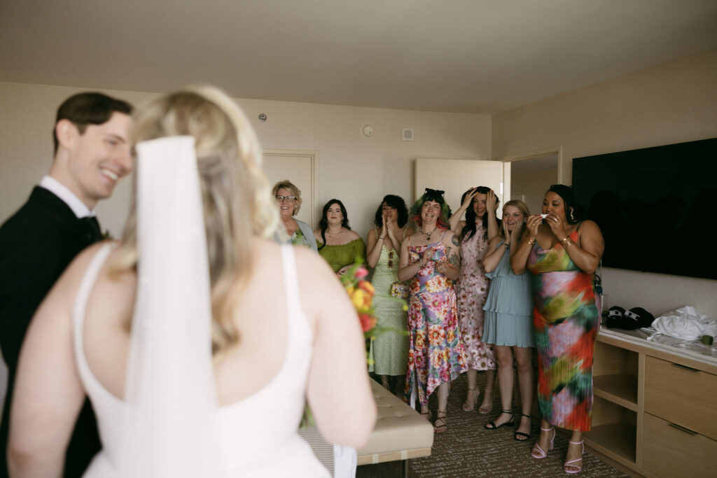 Bride and groom sharing a first look with the bridesmaids 