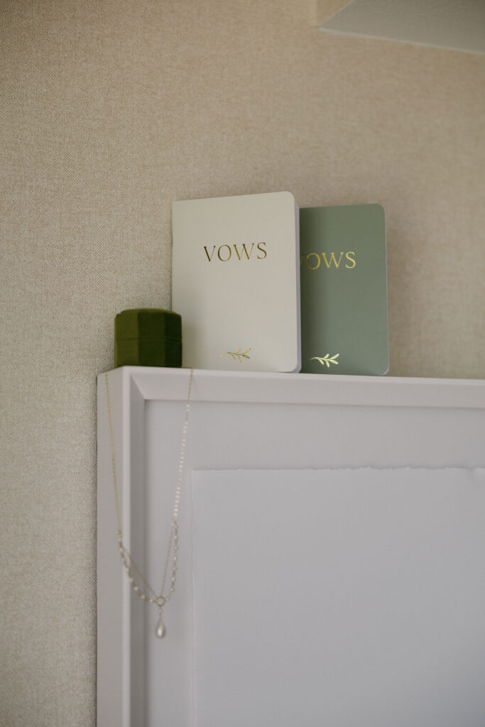 Bride and grooms vow books and ring box for a detail shot