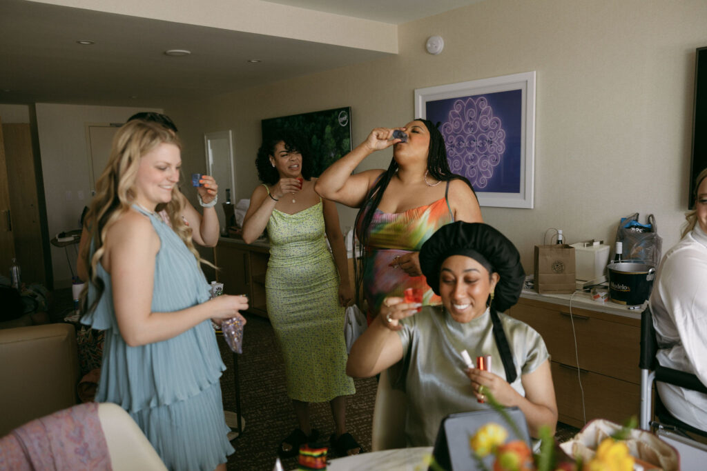Bridesmaids taking shots pre-ceremony