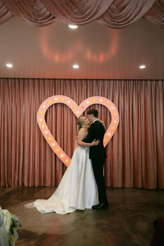 Bride and groom kissing during their Sure Thing Chapel wedding ceremony