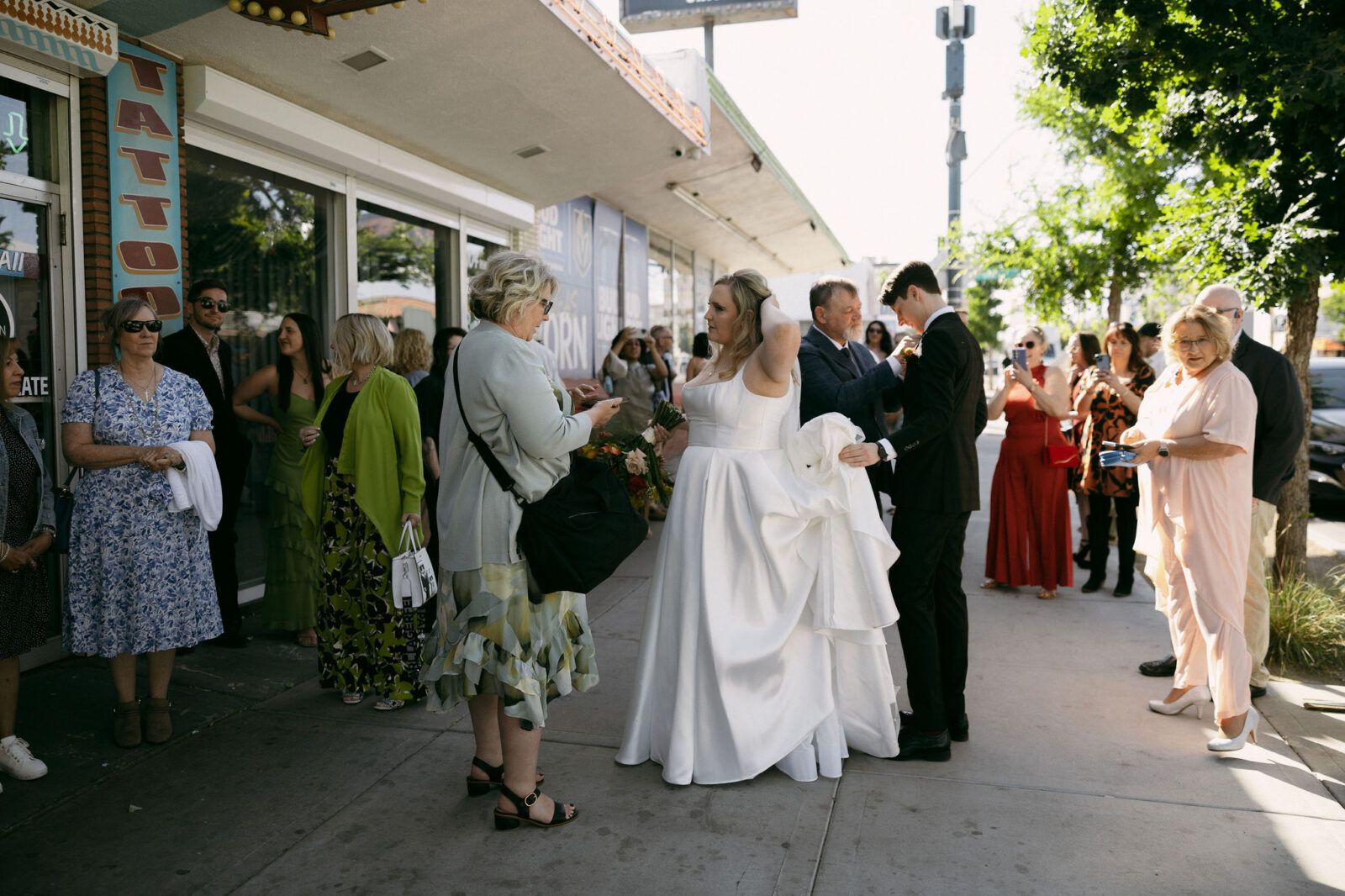 Bride and groom mingling with family outside of Sure Thing Chapel