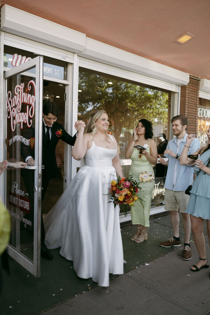 Bride and groom walking out of Sure Thing Chapel