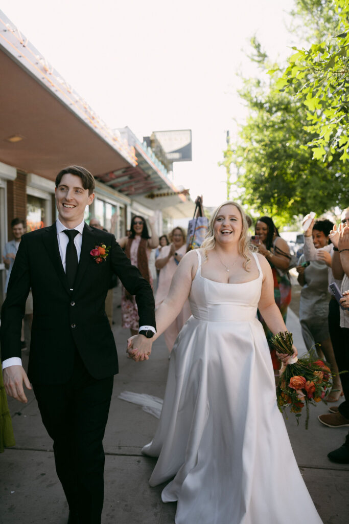 Bride and groom walking out of Sure Thing Chapel