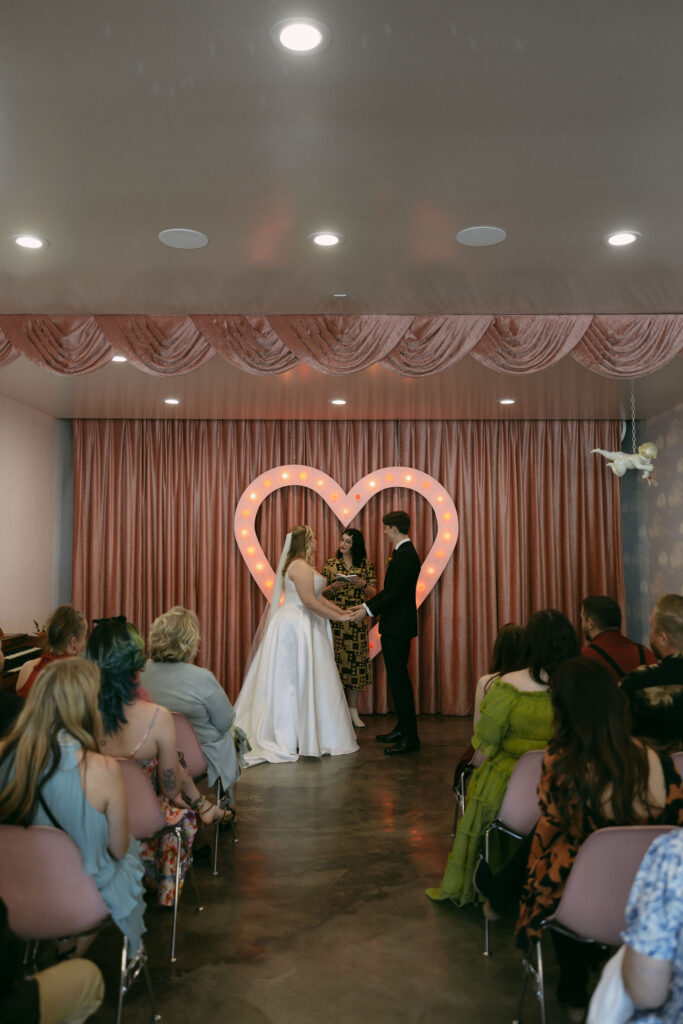 Bride and groom holding hands during their Sure Thing Chapel wedding ceremony