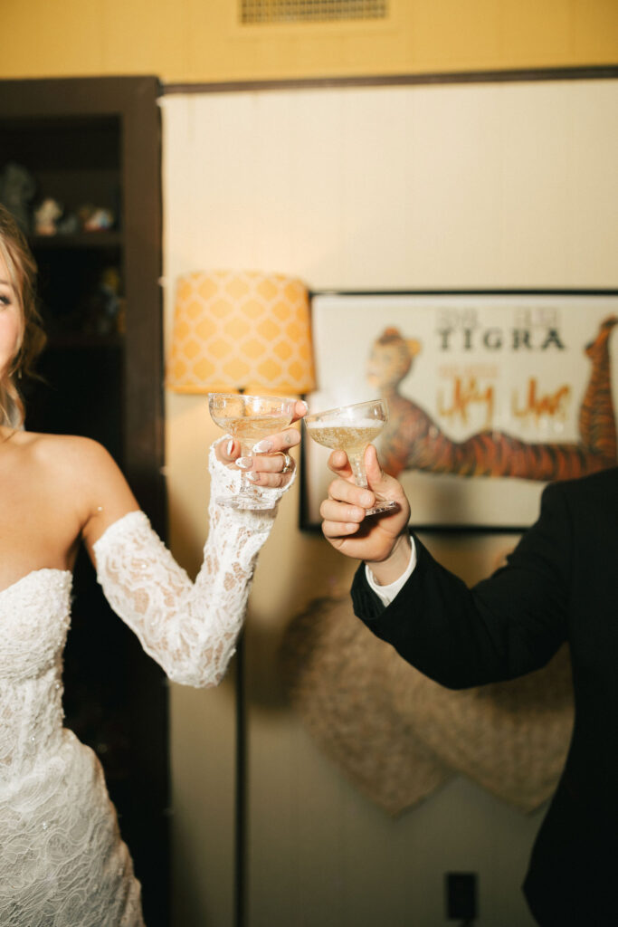 Bride and groom toasting their champagne glasses