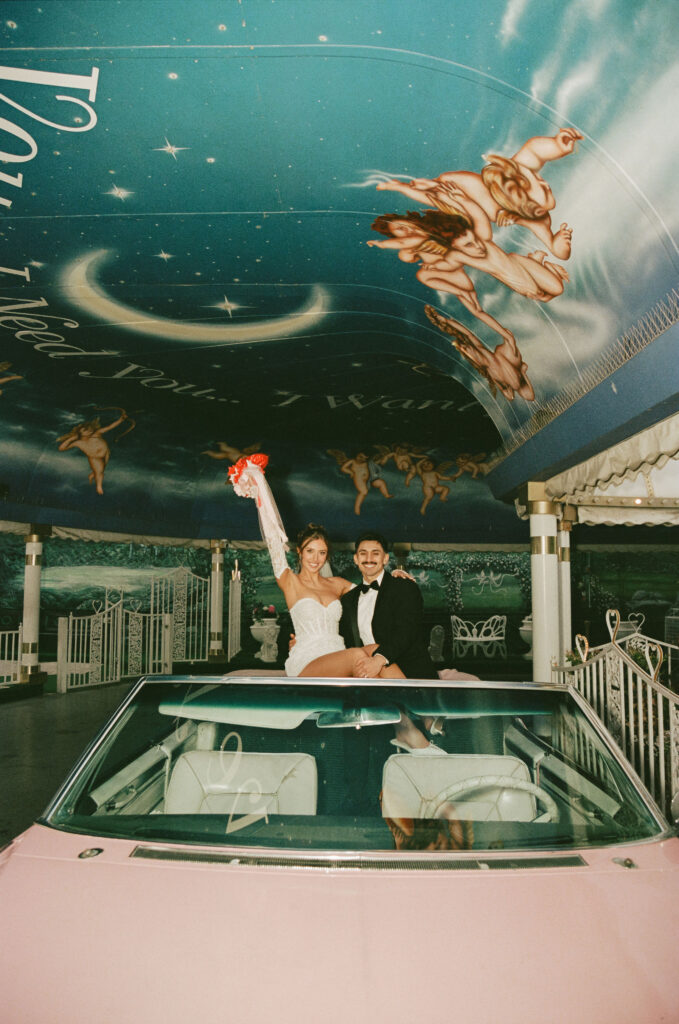 Bride and groom sitting in the back of the Pink Cadillac for their Las Vegas film elopement