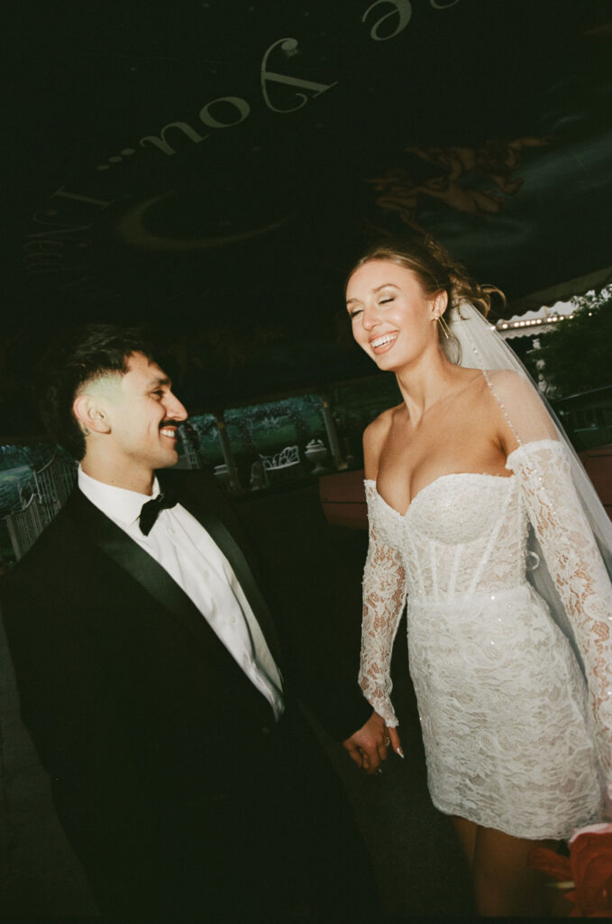 Bride and groom laughing during their Las Vegas elopement at Little White Chapel on film