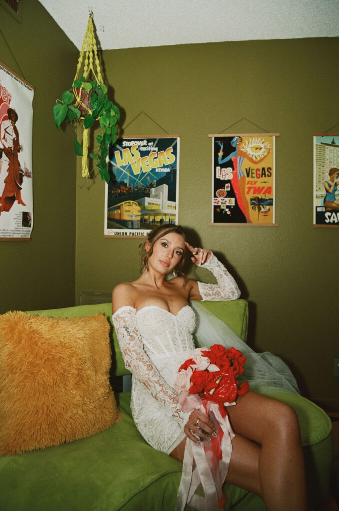 Bride sitting in a vintage green chair for her retro film Las Vegas elopement photos